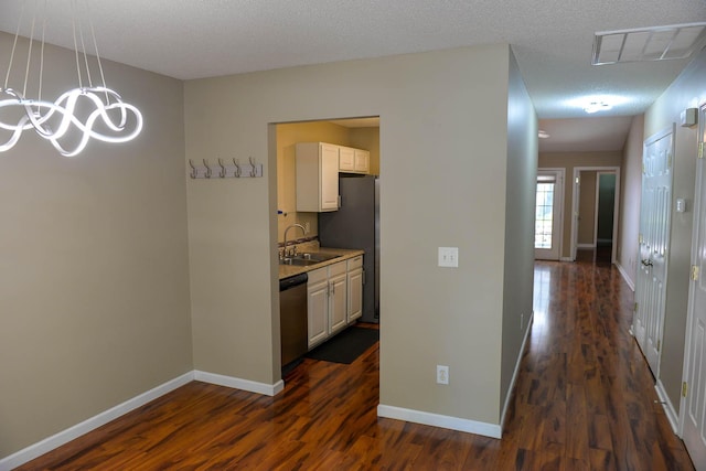 7947 Vermont Rd, North Charleston, SC 29418 - corridor featuring a sink, dark wood-type flooring, and baseboards