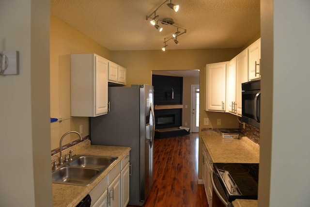 7947 Vermont Rd, North Charleston, SC 29418 - kitchen with electric stove, a sink, a textured ceiling, dark wood-type flooring, and white cabinetry