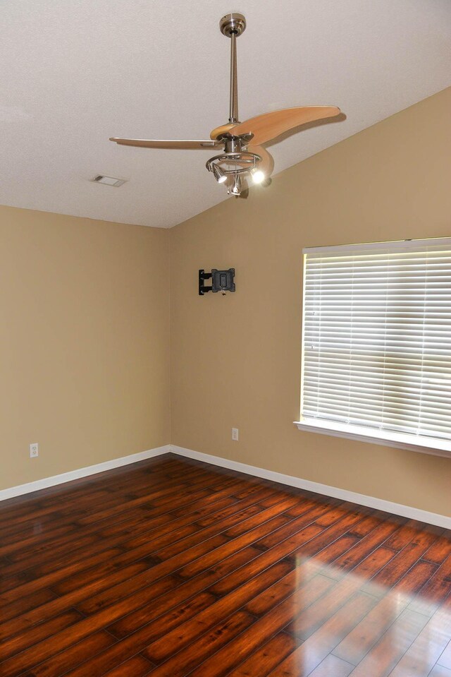 7947 Vermont Rd, North Charleston, SC 29418 - unfurnished room with vaulted ceiling, a ceiling fan, dark wood-style flooring, and baseboards