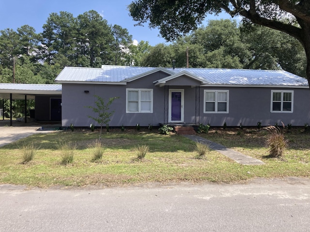 110 Groves St, Walterboro, SC 29488 - ranch-style house with an attached carport, metal roof, a front lawn, and view of scattered trees
