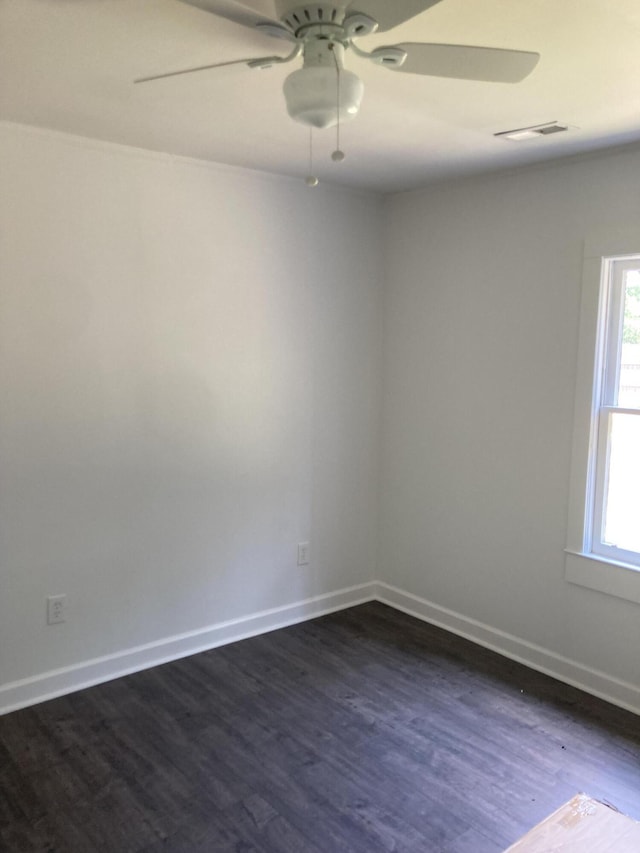 110 Groves St, Walterboro, SC 29488 - empty room with dark wood finished floors, ceiling fan, and baseboards
