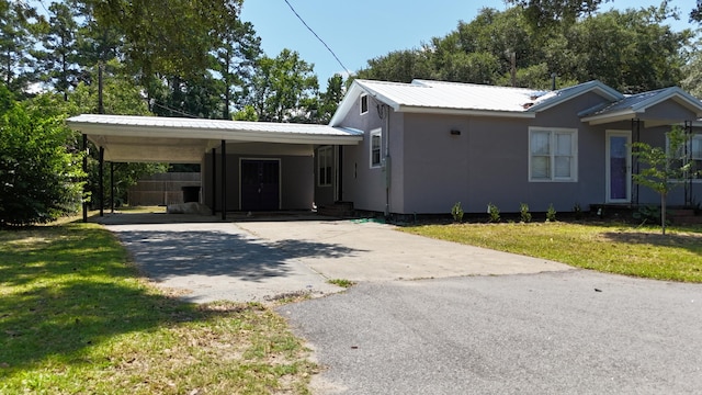 110 Groves St, Walterboro, SC 29488 - ranch-style house featuring driveway, an attached carport, a front yard, and metal roof