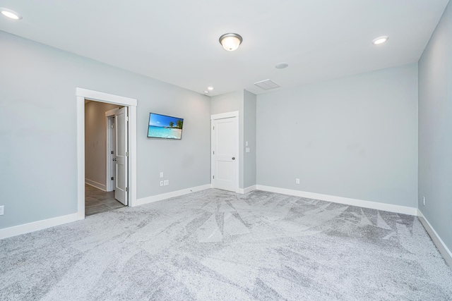 unfurnished room featuring light carpet