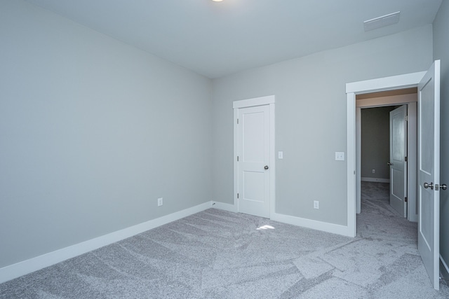 unfurnished bedroom with light colored carpet