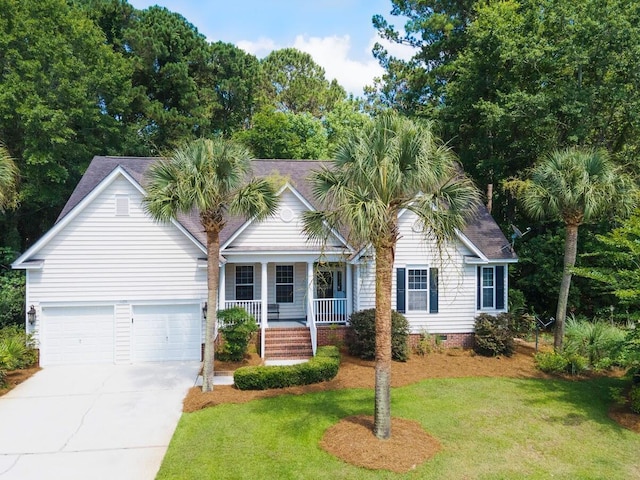 ranch-style house with covered porch, a garage, and a front yard