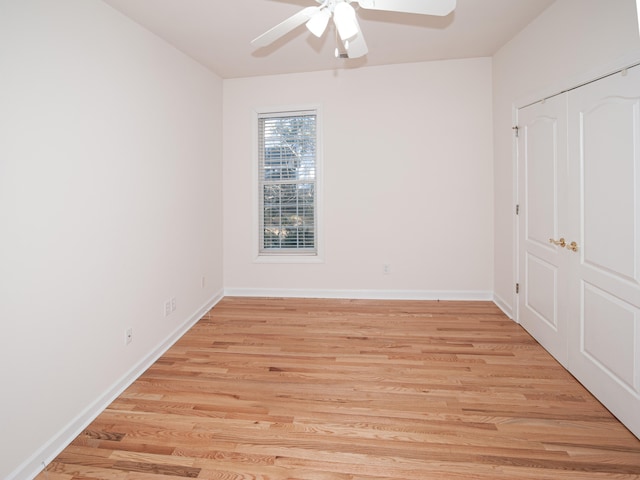 unfurnished bedroom with light wood-type flooring, a closet, and ceiling fan