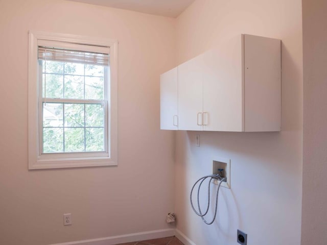 clothes washing area featuring electric dryer hookup, cabinets, and hookup for a washing machine