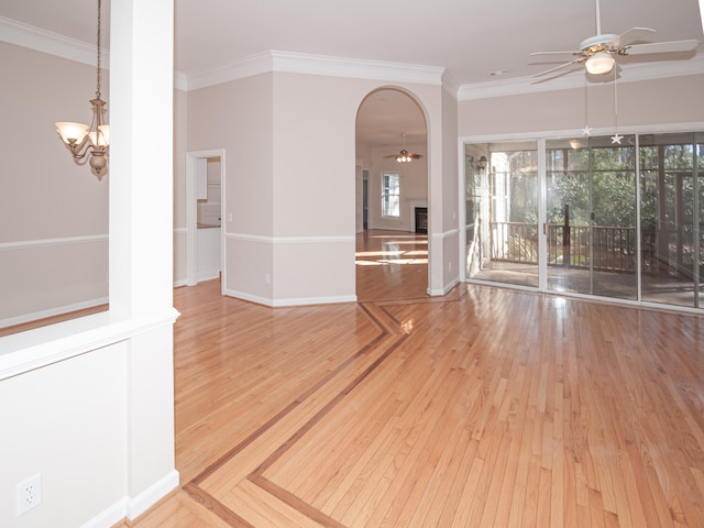 spare room with crown molding, light hardwood / wood-style flooring, and ceiling fan with notable chandelier