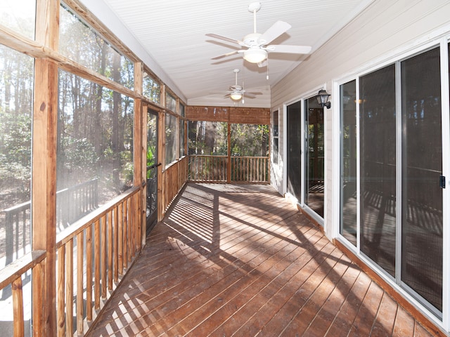 unfurnished sunroom with ceiling fan and lofted ceiling