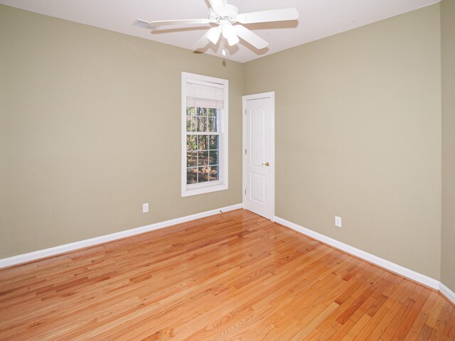 empty room with ceiling fan and light hardwood / wood-style floors