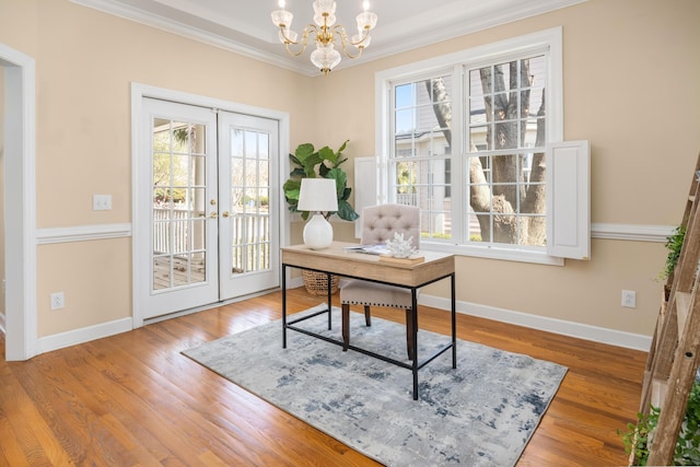 office space with ornamental molding, plenty of natural light, french doors, and hardwood / wood-style flooring