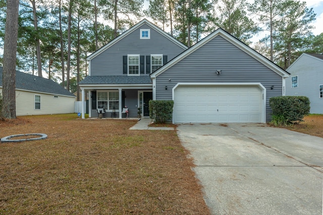 view of front property with covered porch, a front yard, and a garage