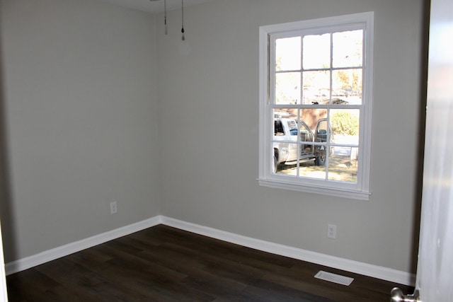 empty room with dark hardwood / wood-style floors