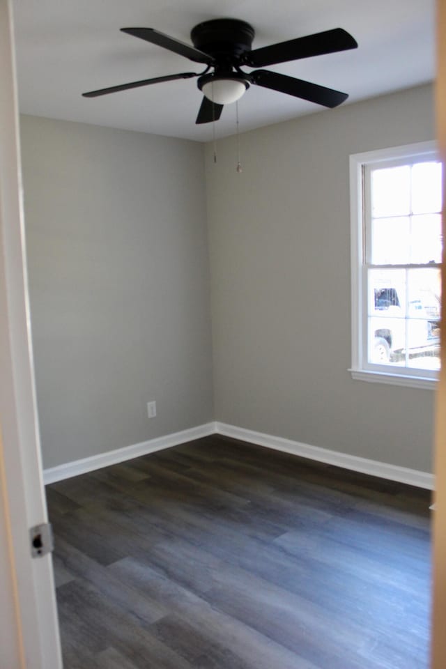 unfurnished room featuring dark hardwood / wood-style floors and ceiling fan