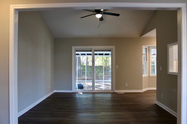 spare room featuring dark wood-type flooring, ceiling fan, and lofted ceiling