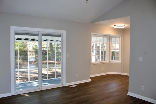 interior space featuring dark hardwood / wood-style flooring and lofted ceiling