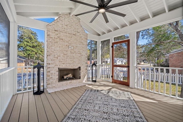 sunroom featuring lofted ceiling with beams and ceiling fan