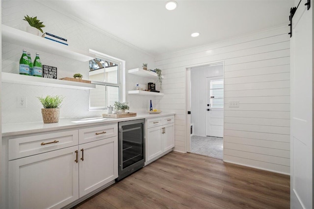 kitchen with beverage cooler, a healthy amount of sunlight, white cabinets, light countertops, and open shelves