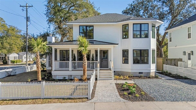 view of front of property with crawl space, covered porch, a fenced front yard, and a shingled roof