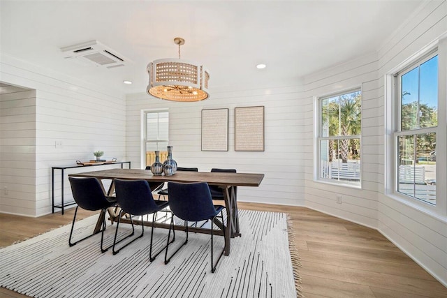 dining area with light wood-style floors, a notable chandelier, and recessed lighting