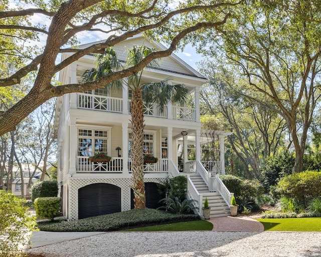 view of front of home featuring a balcony, stairway, and a porch