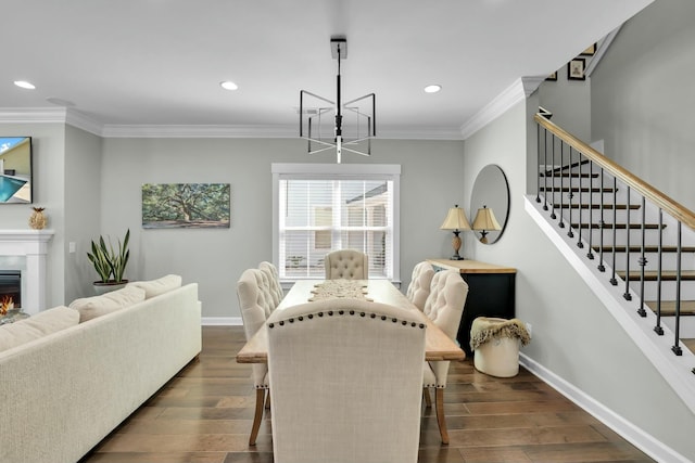 dining area featuring baseboards, stairway, a lit fireplace, ornamental molding, and dark wood-style floors