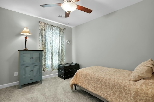 bedroom featuring a ceiling fan, visible vents, baseboards, and light carpet