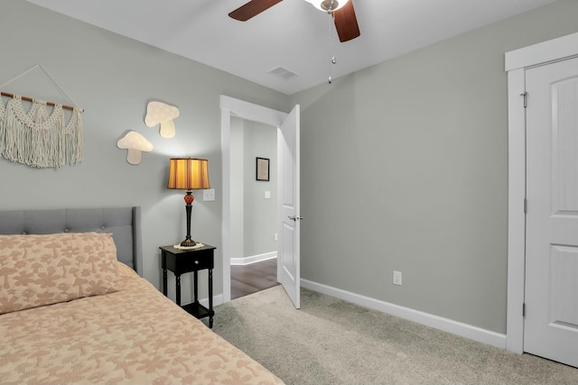 carpeted bedroom with baseboards, visible vents, and ceiling fan