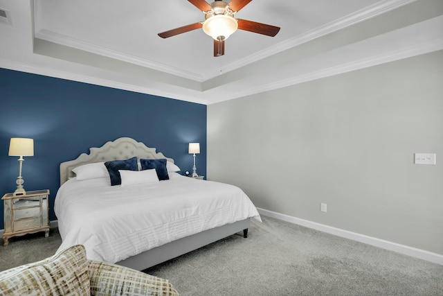 carpeted bedroom with visible vents, a raised ceiling, a ceiling fan, crown molding, and baseboards