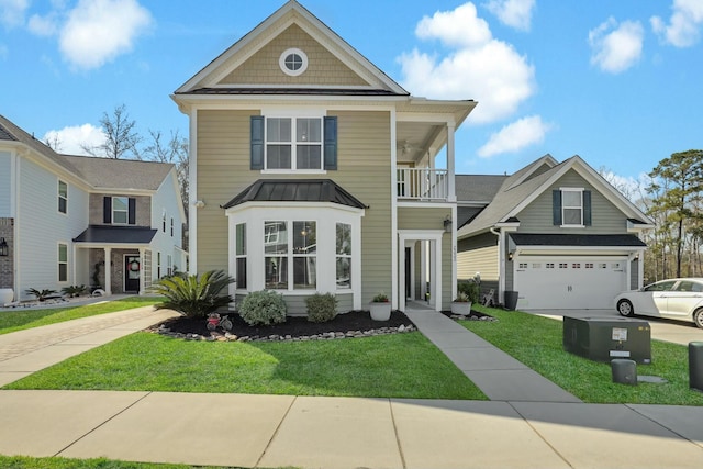 view of front of house featuring a standing seam roof, a front yard, a balcony, and driveway