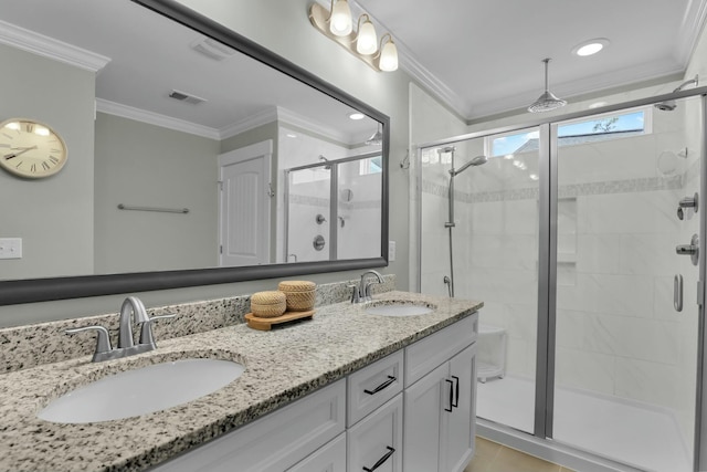 full bath featuring crown molding, a stall shower, and a sink