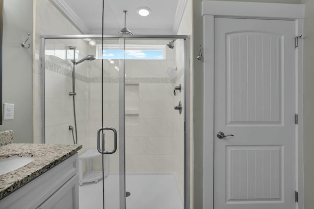 full bathroom with a stall shower, ornamental molding, and vanity