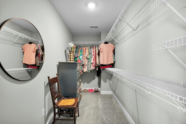 walk in closet with visible vents and carpet floors