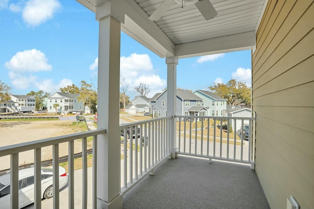 balcony with a residential view and ceiling fan