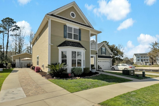 view of front of home with metal roof, a balcony, a front lawn, and a standing seam roof