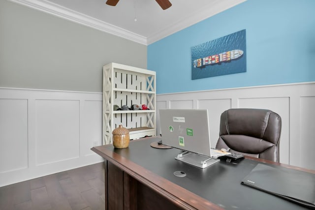 office with ornamental molding, a wainscoted wall, dark wood-style flooring, and ceiling fan