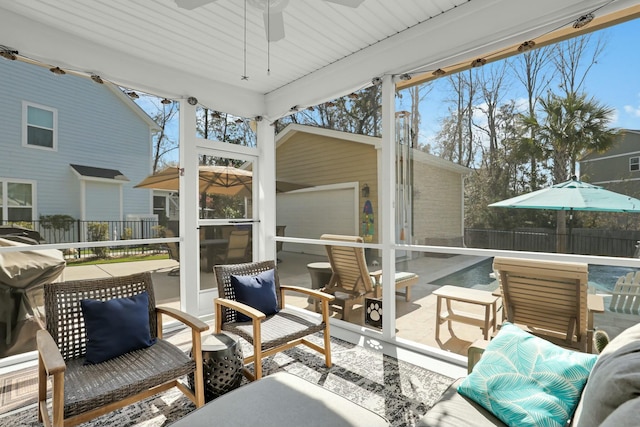 sunroom / solarium featuring plenty of natural light and a ceiling fan