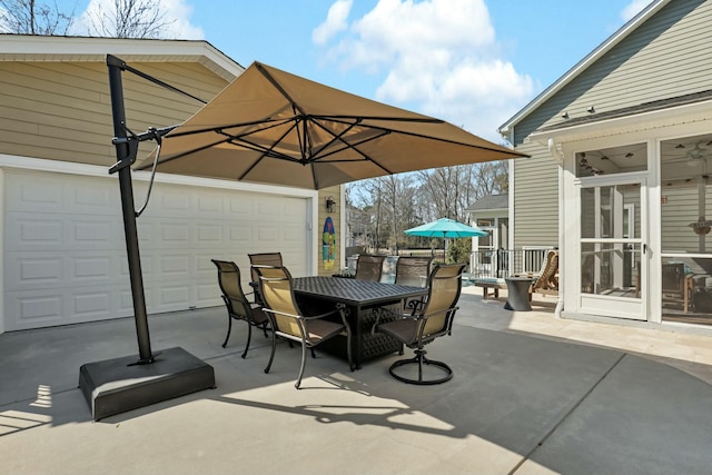 view of patio / terrace featuring outdoor dining area and a garage