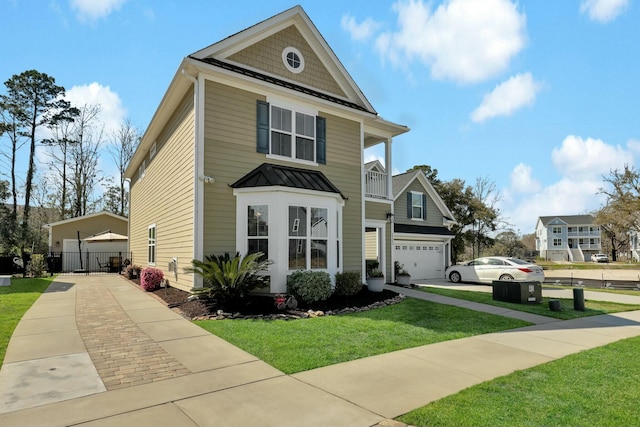 view of front of property with metal roof, a balcony, a front yard, and a standing seam roof