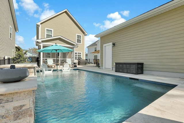 view of pool with a fenced in pool, a patio, a hot tub, and fence