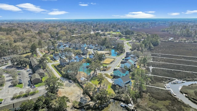 drone / aerial view with a residential view and a water view