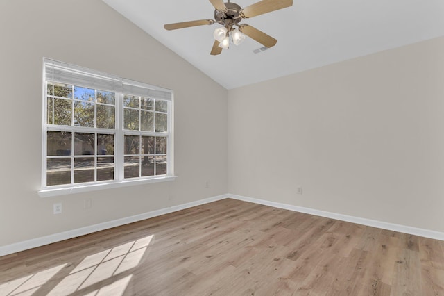 spare room featuring ceiling fan, lofted ceiling, and light hardwood / wood-style floors