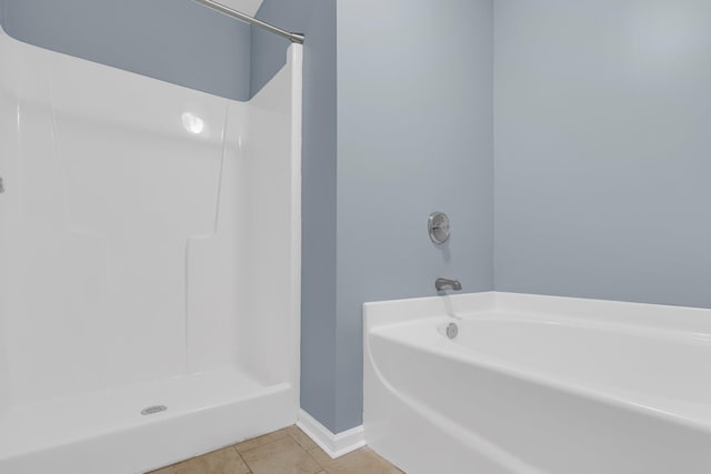 bathroom featuring tile patterned floors and shower with separate bathtub