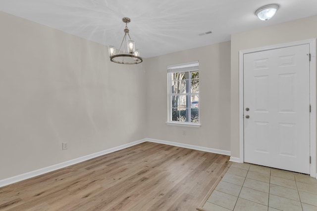 entryway featuring a notable chandelier and light wood-type flooring