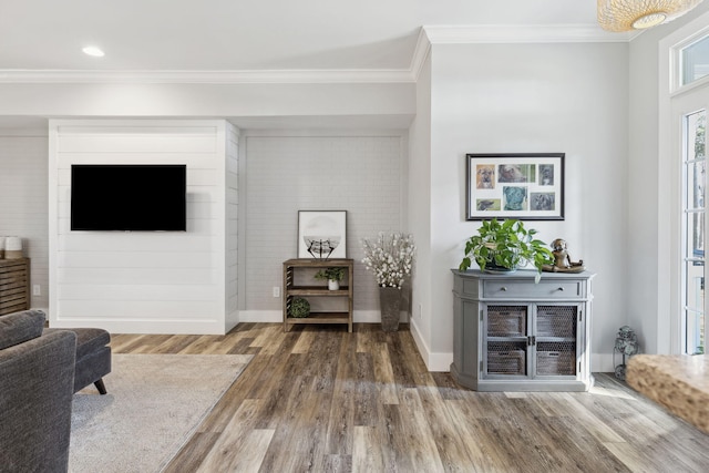 interior space featuring wood-type flooring and crown molding