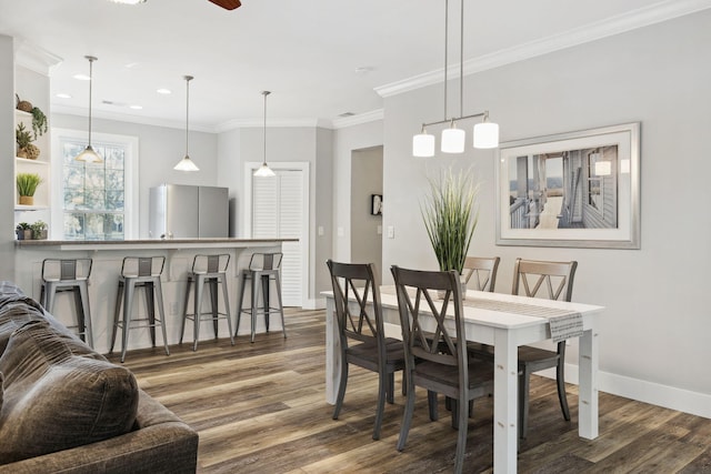 dining area featuring crown molding, ceiling fan, and hardwood / wood-style floors