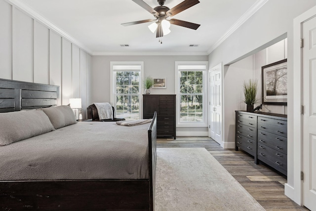 bedroom featuring crown molding, ceiling fan, and hardwood / wood-style floors