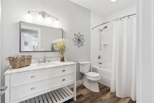 full bathroom featuring vanity, hardwood / wood-style floors, toilet, and shower / tub combo