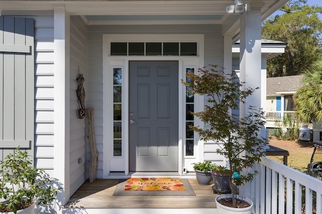 view of exterior entry with a porch