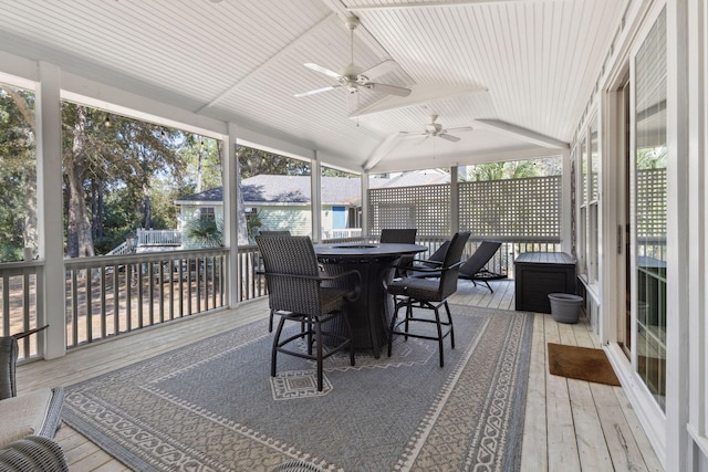 sunroom with lofted ceiling, wood ceiling, and ceiling fan